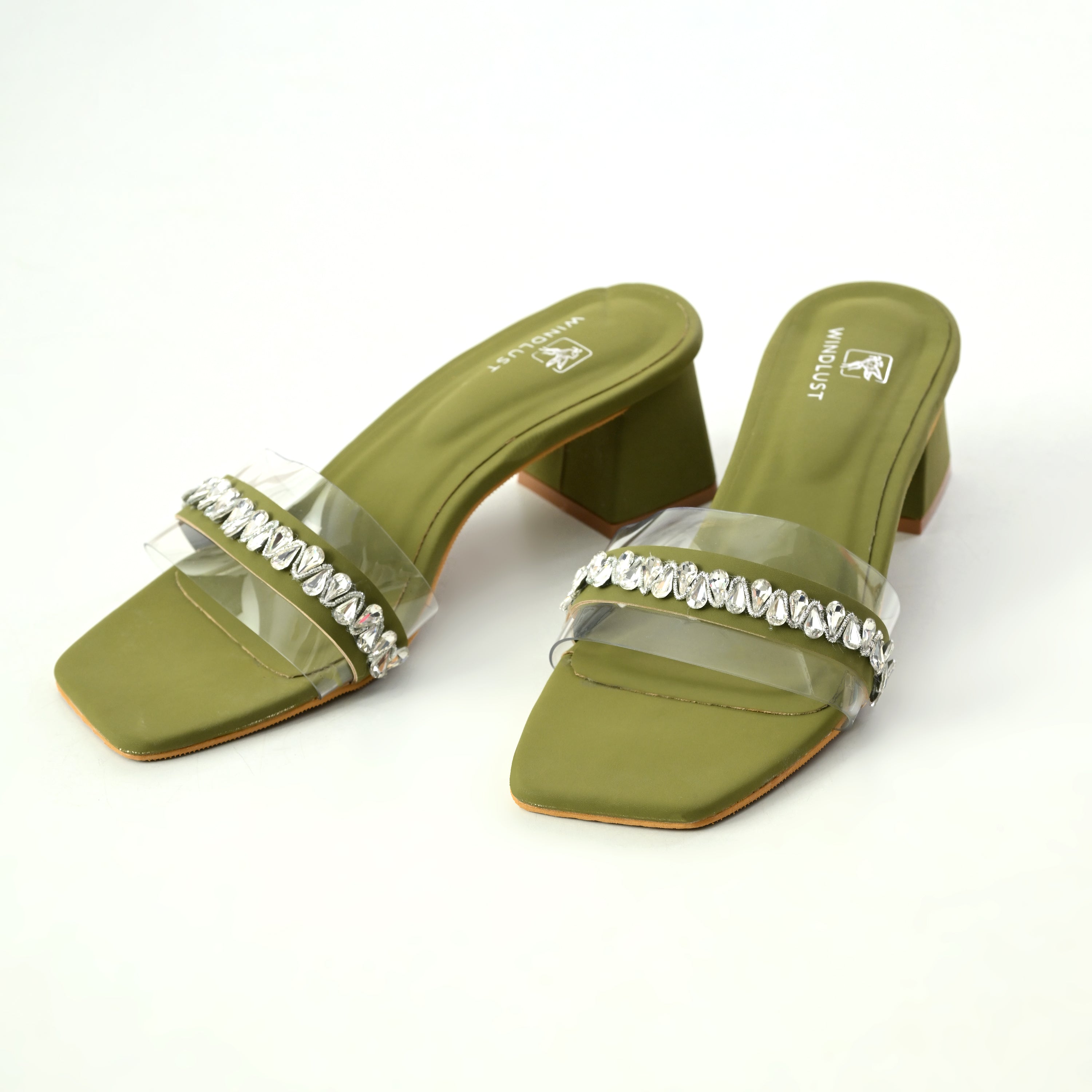 Windlust clear heels with Swarovski embellishments and deep green accents, stylish open-toe design, and high stiletto heels.