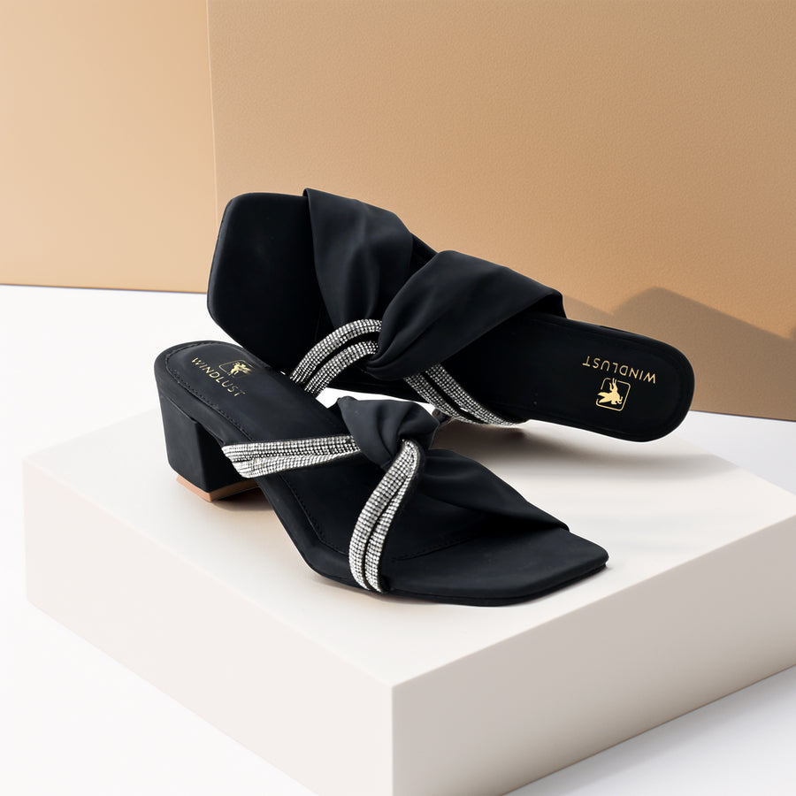 Black Windlust interlocked Swarovski string heels with elegant design and sparkling embellishments, showcasing the stylish footwear.