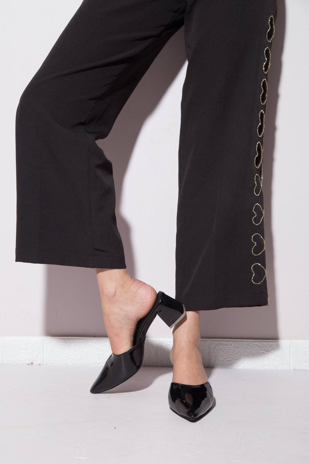 Solid black Windlust mule shoe featuring a sleek design, perfect for casual or dressy wear.