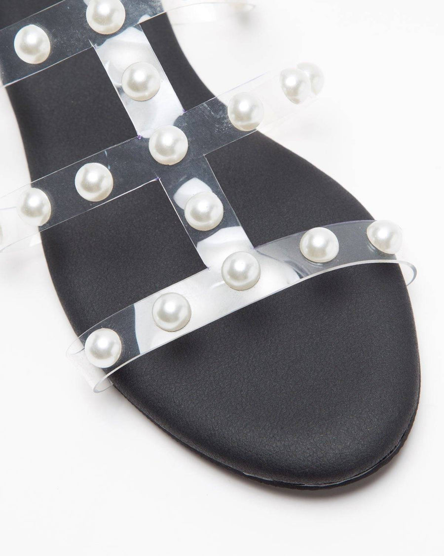 Black flats with three straps and pearl embellishments by Windlust, featuring a stylish and comfortable slip-on design.