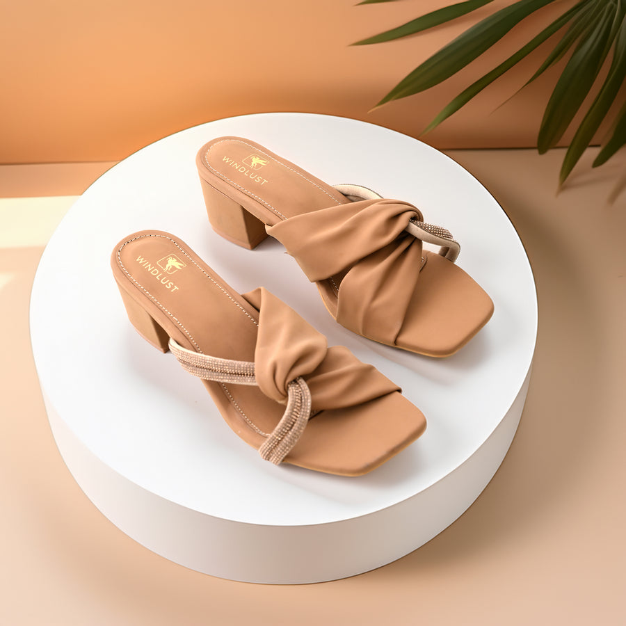 Beige Windlust interlocked Swarovski string heels, stylish high-heeled shoes with sparkling embellishments and elegant design.