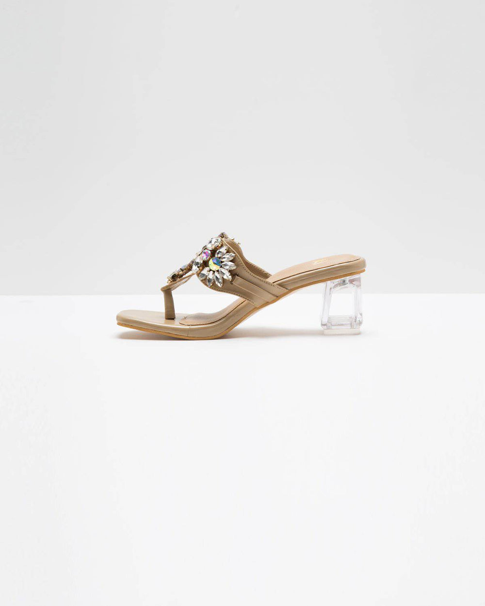 Nude shade Kohlapuri stone-embellished heels by Windlust with traditional design and intricate embellishments.