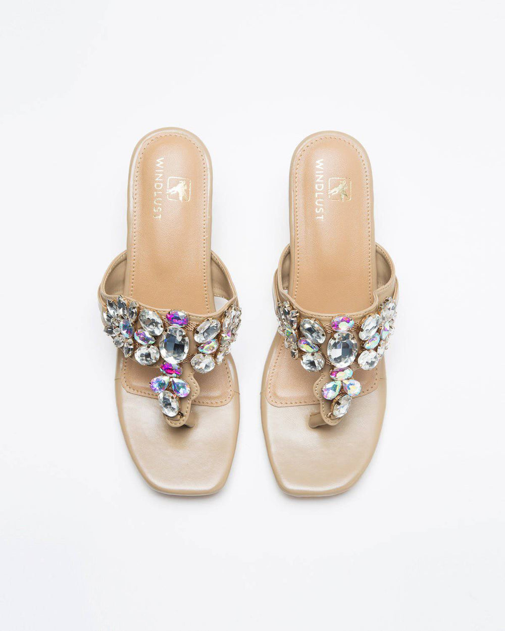 Nude shade Windlust Kohlapuri heels with stone embellishments, showcasing intricate design and elegant open-toe style.