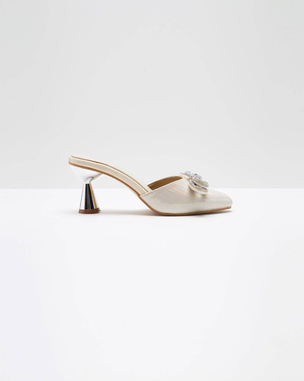 Metallic cream embellished bow heels by Windlust featuring a sleek design and decorative bow detail.