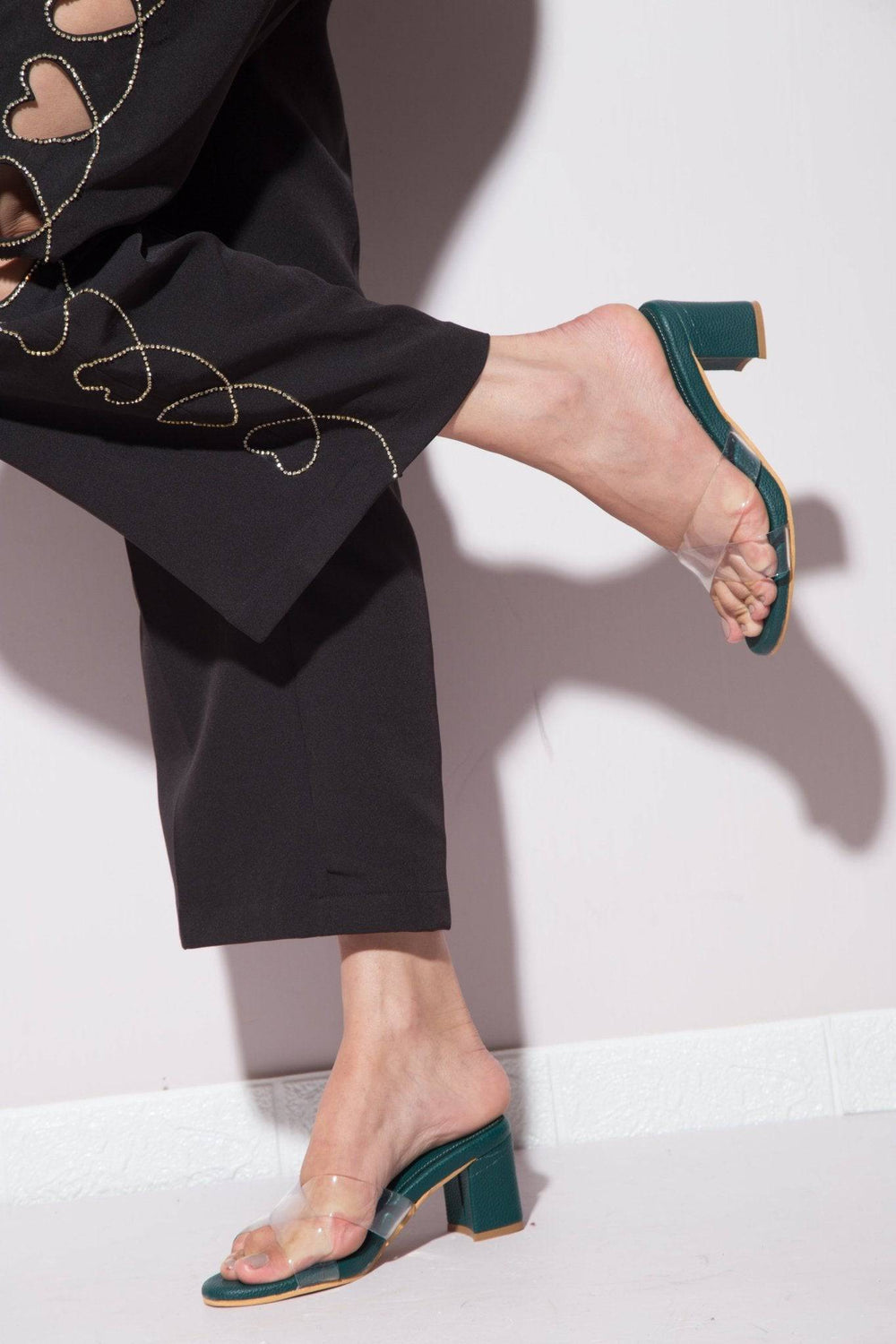 Emerald green transparent cross-strapped heels from Windlust featuring elegant open-toe design and high stiletto heels.