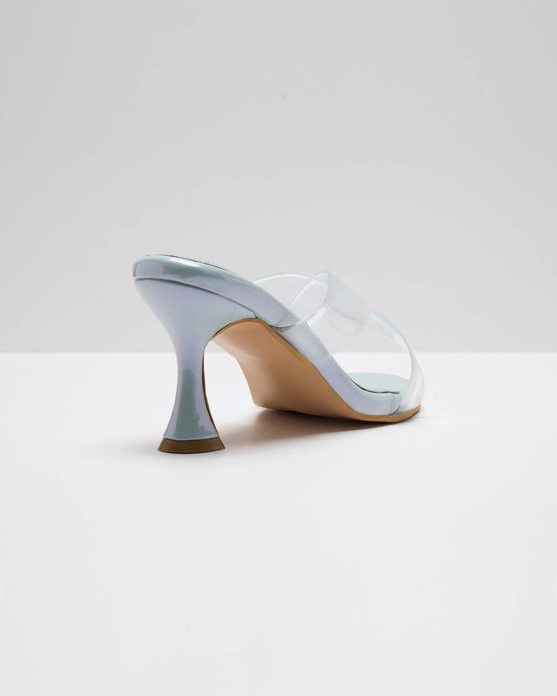 Light metallic blue transparent cross-strap pumps by Windlust, stylish heeled shoes with a sleek, modern design.