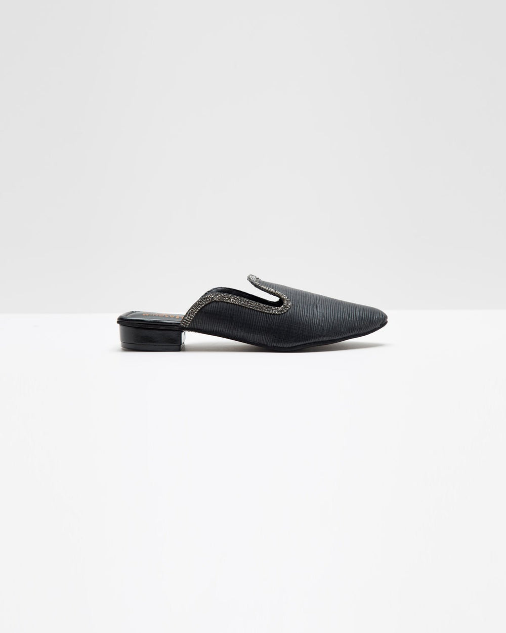 Fine textured black mules by Windlust featuring a sleek design and pointed toe, perfect for stylish, comfortable footwear.