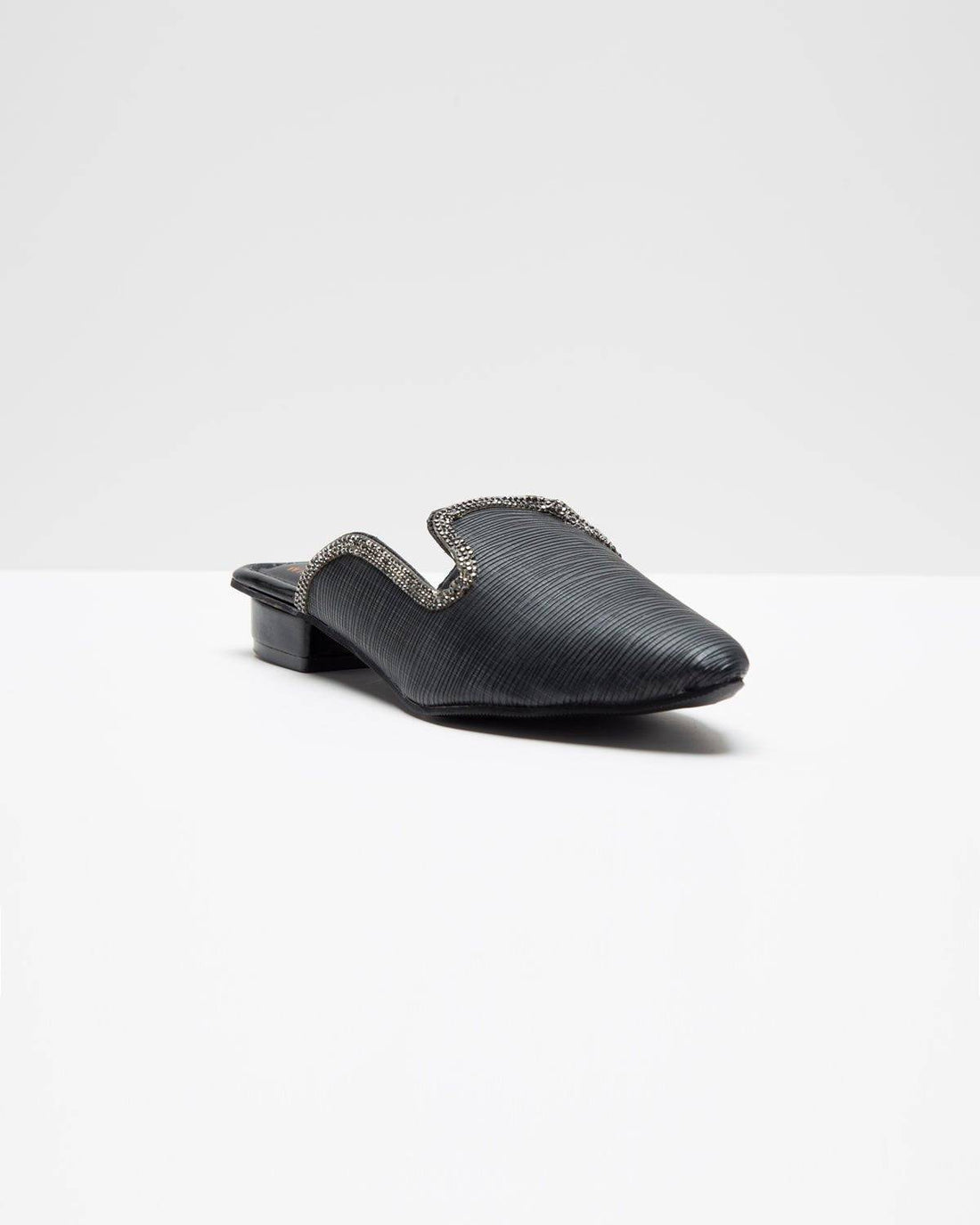 Fine textured black mules by Windlust, stylish slip-on footwear with a sleek design and comfortable fit.