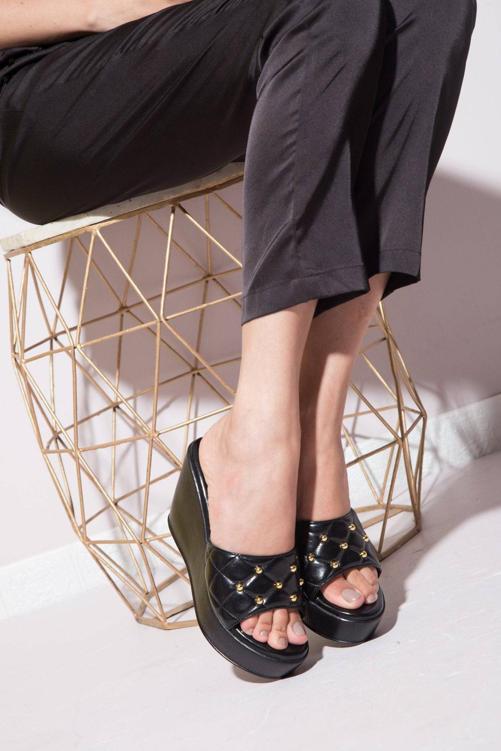Glossy black Quilt 'n' Stud High Wedge from Windlust, showcasing the stylish wedge shoes with quilted and studded details.
